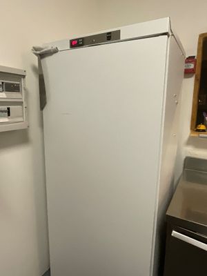 a white refrigerator in the corner of a kitchen