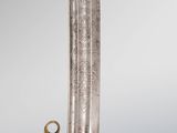 a close up of a sword with a gold handle on a gray background