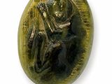 an image of a bronze button with a monkey on it