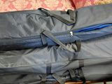 two suitcases sitting on top of a wicker chair
