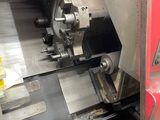 an image of a machine that is working on a piece of metal