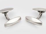 a pair of silver cufflinks on a white background