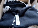 a box that has a pair of socks and a scarf in it