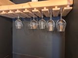 a wine glass rack with wine glasses hanging from it
