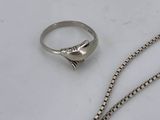 two rings and a chain on a white surface