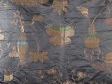 a black cloth with a picture of animals and plants on it