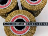 three wheel brushes with a measuring tape on top of them