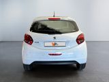 the rear end of a white car parked in a garage