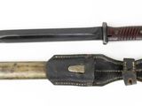 two knives are sitting side by side on a white surface