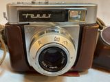 a brown camera with a brown strap around it