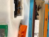 many different types of toy trains in boxes on the table