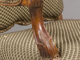 an image of a chair with a wooden arm rest