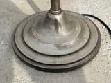 a metal lamp that is sitting on the ground