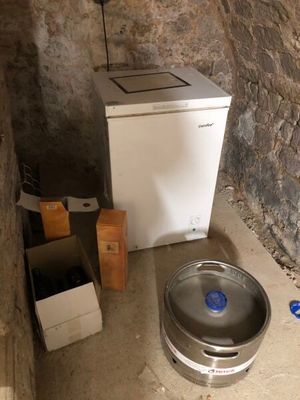 an image of a small room with a sink and a refrigerator