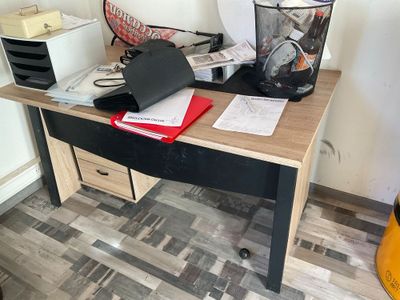 a desk with a laptop on it in a kitchen