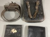 two pieces of leather and a wallet are sitting on a table