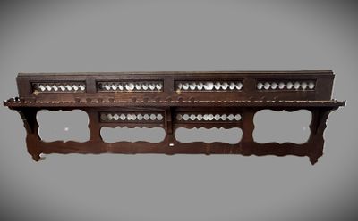 an image of a wooden shelf with a bunch of holes on it