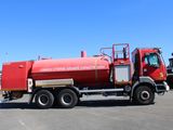 a large red tanker truck parked in a parking lot