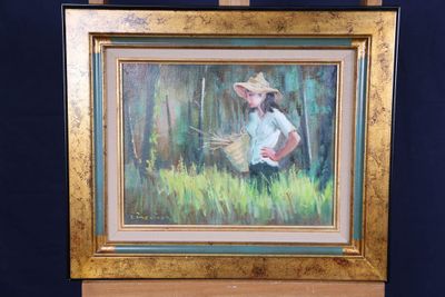 un tableau représentant une femme coiffée d'un chapeau de paille, posé sur un chevalet