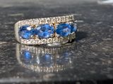an image of a diamond and sapphire ring on a table