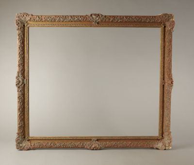 an ornate gold framed mirror against a white background