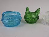 three different colored glass dishes sitting next to each other on a white surface