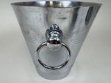 a silver vase with a ring in it on a table