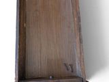 a small wooden box with a screw in it