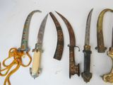 several different types of knives are displayed on a white surface