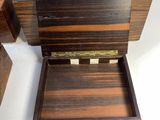 a small wooden box that is open on a white surface