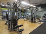 a gym with a lot of machines in the room