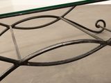 a glass table with a metal frame and a glass top