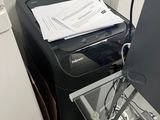 a stack of papers sitting on top of a desk next to a washing machine