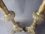 pair of antique brass candlesticks on a blue background