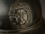 a close up of a helmet with a lion head on it
