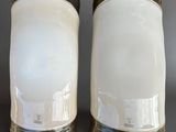 pair of white salt and pepper shakers with gold rims