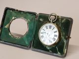 a small green box with a clock inside of it