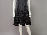 a black leather dress with ruffles on a mannequin mannequin mannequin mannequin mannequin mannequin mannequin mann