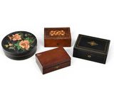 three small wooden boxes sitting next to each other on a white surface