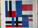 painting of red, black, blue, and white squares in a white frame