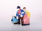 two figurines of people standing next to each other