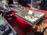 a counter that has a laptop on it in a store