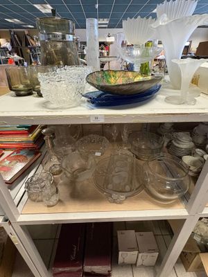 a shelf with a lot of glass items on it