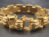 an image of a gold bracelet on a table