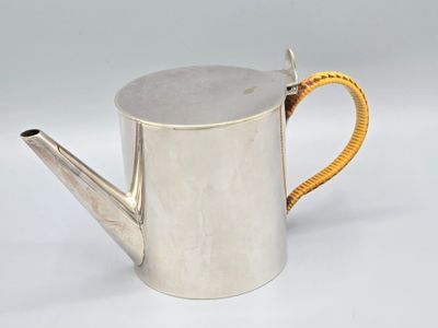 silver metal watering can with a yellow handle on a white background