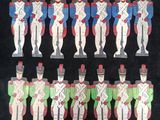 several wooden toy soldiers are lined up on a black surface