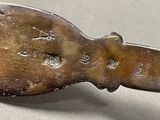 a silver spoon with writing on it sitting on a table