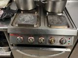 pots and pans sit on top of a stove in a kitchen