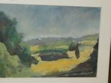 painting of a landscape in a frame on a wall