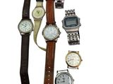 a lot of watches that are sitting on a table